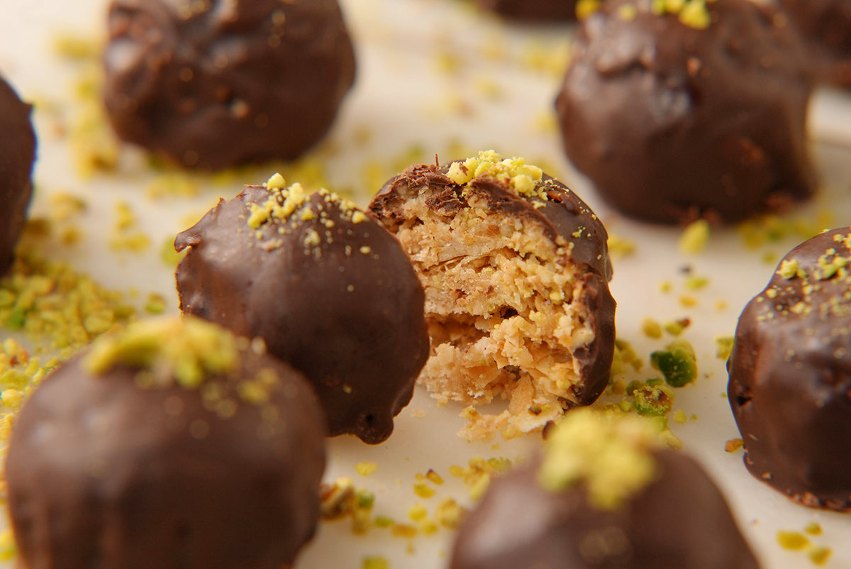 Several Sogarina Cupole, our chocolate-covered baklava, featuring a split Cupole revealing the crunchy inside.
